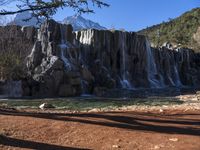 there's no image above that includes a waterfall, and only this one is a mountain in the back