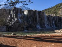 there's no image above that includes a waterfall, and only this one is a mountain in the back