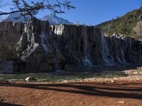 there's no image above that includes a waterfall, and only this one is a mountain in the back