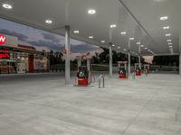 the interior of a shell gas station lit up with red lights and red gasoline pumps