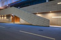 a staircase leading up to an underground parking garage at night with blue lights on it