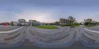 the empty park and grassy area in the city, with multiple circular mirrors visible to provide an optical effect