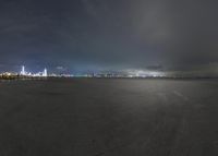 the image shows the wide view at night time as well as the city lights in the background