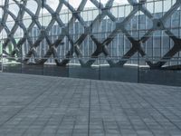 an image of a large building inside a glass structure of glass and a couple of people standing with luggage