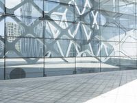 an image of a large building inside a glass structure of glass and a couple of people standing with luggage