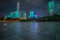 a view of a street and city skyline at night time in china with its lights on