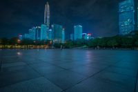 a view of a street and city skyline at night time in china with its lights on