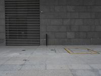 a sidewalk with some yellow and black squares around it and a door at the front