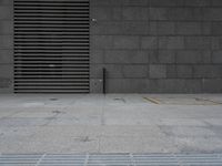 a sidewalk with some yellow and black squares around it and a door at the front