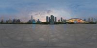 a panoramic picture of a view of buildings and sky, from a stone walkway