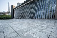 a large building with tall glass windows on a gray background in hong, china - asia