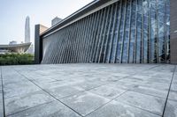 a large building with tall glass windows on a gray background in hong, china - asia