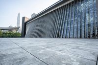 a large building with tall glass windows on a gray background in hong, china - asia