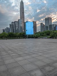 a very big square in the city with a view of it with blue glass building and skyscraper in the background