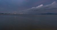 the water has very large chunks of blue in it and a skyline of large buildings in the background