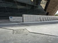 a man is skateboarding and taking a photo with his cellphone in front of a building