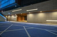 empty parking space and stairs inside the city at night time under lit up lights and windows