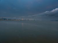 the water has very large chunks of blue in it and a skyline of large buildings in the background