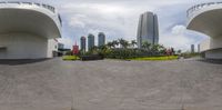 a panoramic image of some buildings in an urban setting and there is only one red balloon