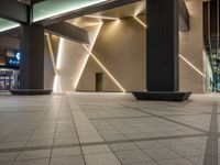 a hallway with columns on the wall that have led lights coming out of them and a door is behind the wall