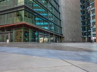 two city buildings along a wet street with a fire hydrant on the sidewalk in front of the building