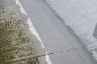 a very nice looking sidewalk with some stains on them, next to a train track