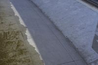 a very nice looking sidewalk with some stains on them, next to a train track