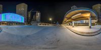 the fisheye shot is taken at night of a skate park in the city of atlanta