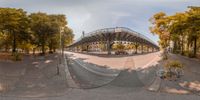 the view of a skateboard ramp is in the middle of this skate park image