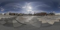 a fisheye view of a skate park with the sun in the background behind it