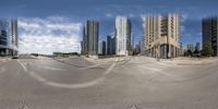 a skate park in the middle of a big city with skyscrapers in the background