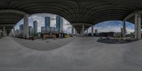 a wide angle image taken from a fisheye lens of a skate park with skateboarders