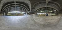 a reflection in a fisheye lens on the ground of a skate park inside an auditorium