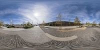 an image of a panorama of two people at a skate park being shown in a fish eye mirror