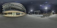 this is an 360 camera view of a skate park at night, of a curved structure