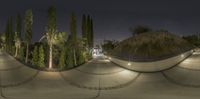 this photo is taken with a fish eye lens of the skate park at night time