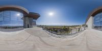 the spherical view of the ramp and exterior area at an outdoor skate park with blue sky