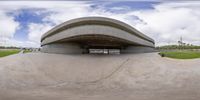 a skate park is in the middle of a curve pattern and people are riding bicycles