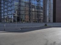 a person on skateboard riding past a tall building in the middle of a city