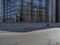 a person on skateboard riding past a tall building in the middle of a city