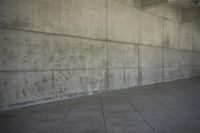 a skateboard in a concrete building and its shadow on the ground to show it