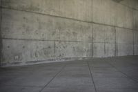 a skateboard in a concrete building and its shadow on the ground to show it