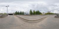 a person on a skateboard riding a half pipe at the edge of a ramp