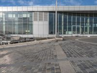 the skateboard is in front of a building and a walkway beside it that appears to have been set up into concrete