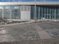 the skateboard is in front of a building and a walkway beside it that appears to have been set up into concrete