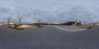 skateboarding at a skateboard park with a snow bank and lights in the background