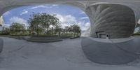 a skateboard park has many large objects on the ground in it's reflection