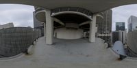 an indoor skateboard park with skate ramp and ramps in the center of it, over a city skyline