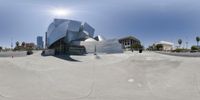 the fisheye view shows a skateboard park at daytime and is mostly empty of people