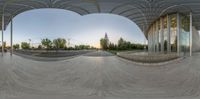 a skateboard park with people skateboards on it in the day time and the sun setting